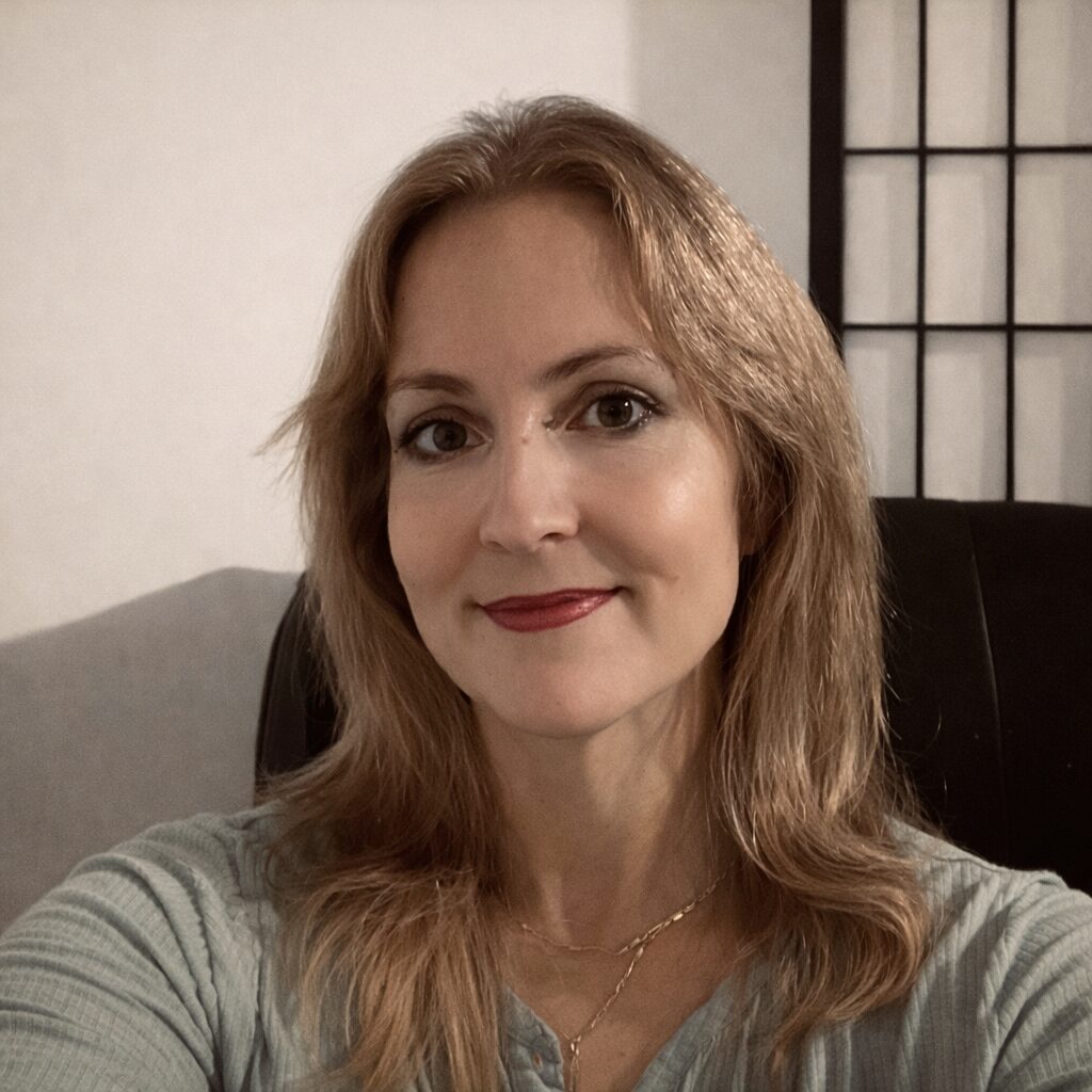 Therapist, Crystal Sombatphibane, sitting in her relaxing therapy office.